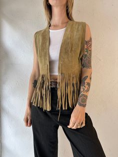 - Vintage Bagatelle suede fringe vest - Made in Canada - Small red mark on back right shoulder - Tagged 13 Chest: 17" Length: 23" We are not responsible for lost, stolen, or damaged packages once they have been shipped. Any additional customs duties or taxes incurred on international orders are the responsibility of the buyer. Please note that our items are vintage and may have minor flaws or imperfections due to their age, which adds to their unique character. Brown Fringe Vest For Festival, Leather Fringe Vest, Western Fringe Vest, Bohemian Brown Fringe Vest, Suede Fringe Vest, Fringe Vest, Red Marks, Suede Fringe, Vest Outfits