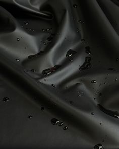 water drops on the black fabric as it is draped with dark colored material