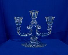 two crystal candlesticks on a blue background