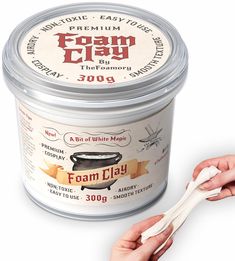 a person holding a spoon in front of a can of foam clay