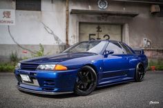 a blue car parked in front of a building