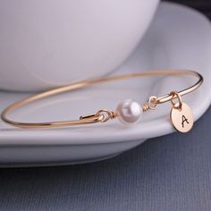 Gold Bangle Bracelet  White Pearl Bracelet by georgiedesigns Personalized Classic Pearl Bracelet, Classic Personalized Pearl Bracelet, Elegant Personalized Round Pearl Bracelet, Elegant Bangle Name Bracelet For Bridesmaid Gift, Elegant Personalized Adjustable Pearl Bracelet, Classic Rose Gold Pearl Bracelet Gift, Elegant Adjustable Personalized Pearl Bracelet, Classic Rose Gold Pearl Bracelet As Gift, Elegant Charm Bracelet For Personalized Gift