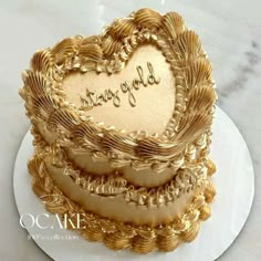 a heart shaped cake with the words congratulations written on it's side, sitting on a white plate