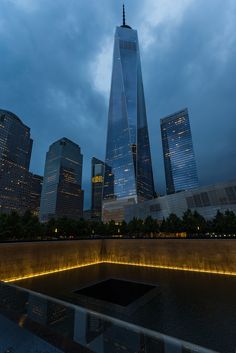 the world trade center is lit up at night