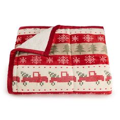 a red and white blanket with trucks on it