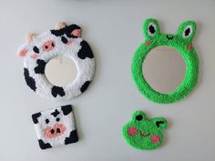 three pieces of crochet are arranged on a surface, including a mirror and cow head