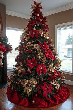 a christmas tree decorated with gold and red poinsettis