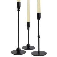 two black candles are standing next to each other