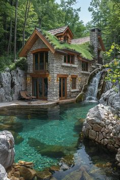 a house with a pool in front of it and a waterfall coming out of the back