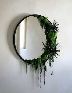 a circular mirror with moss growing on it