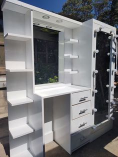 a white desk with drawers and shelves on the outside