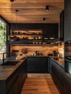 a kitchen with wooden walls and black cabinets is seen in this image from the inside