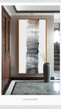 a large painting hanging on the wall next to a vase