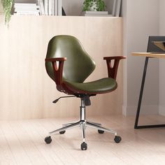 a green office chair sitting on top of a wooden floor next to a desk and bookshelf