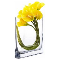 yellow flowers are in a clear square vase