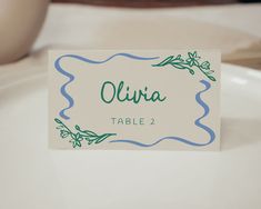 a place card sitting on top of a white plate