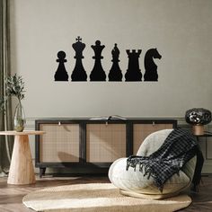 a living room filled with furniture and a giant chess board wall decal