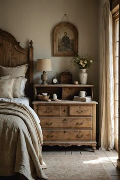 a bed room with a neatly made bed and a wooden dresser next to a window