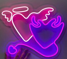 a neon sign with a heart and wings on it