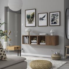 a living room filled with furniture and pictures on the wall