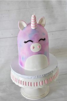 a cake with a unicorn face on top of it