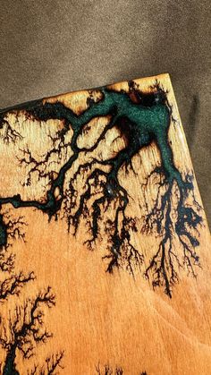 a piece of wood that has some trees on it