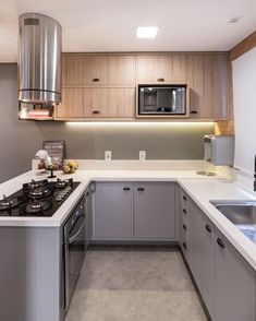 a kitchen with stainless steel appliances and white counter tops