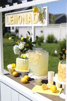 a lemonade stand with yellow and white decorations