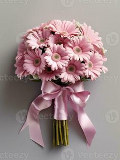 a bouquet of pink daisies tied to a wall