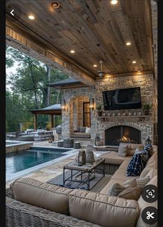 an outdoor living area with couches and fireplace