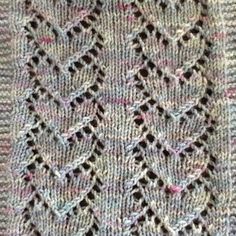 a close up of a knitted sweater with an intricate design on the front and back