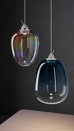 two different colored glass lights hanging from strings