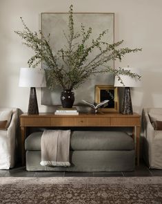 a living room filled with furniture and a painting