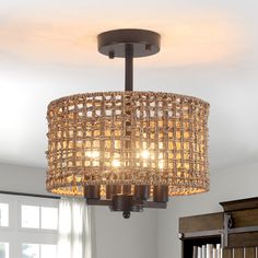 a chandelier hanging from the ceiling in a living room