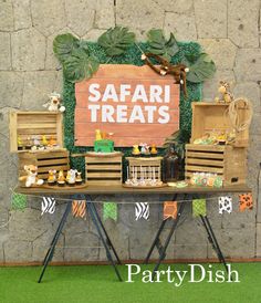 a safari themed dessert table is set up for a party