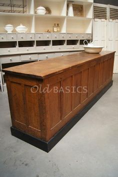 an old fashioned kitchen island in the middle of a room