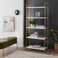 a living room filled with furniture and a book shelf next to a green bench in front of a wall