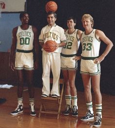 three basketball players standing next to each other on a court with a ball in their hands