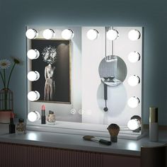 a vanity mirror with lights on it in front of a painting and flower vases