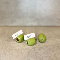 three pieces of green fruit sitting next to each other on top of a countertop