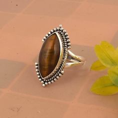 Tigers Eye Ring, Chunky Vintage Statement Ring, Natural Gemstone Ring, Womens Jewelry, Gift For Her * Material: High Quality Solid 925 Sterling Silver * Finish: Oxodised Silver Tiger Eye is a type of chatoyant gemstone that is prized for its unique, iridescent sheen. It's a type of quartz that has been subjected to high pressure and temperature, which causes the formation of fibers that create a shimmering, layered effect. Color: Tiger Eye typically has a golden, yellow-brown color with a metall Fine Jewelry Natural Stones Ring For Anniversary, Fine Jewelry Anniversary Rings With Natural Stones, Anniversary Rings With Natural Stones In Fine Jewelry Style, Luxury Rings With Natural Stones For Anniversary, Luxury Natural Stones Ring Jewelry, Luxury Natural Stone Ring Jewelry, Luxury Jewelry Ring With Natural Stones, Luxury Sterling Silver Gemstones, Brown Oval Gemstone Rings