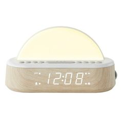 an alarm clock with the time displayed on it's display stand and wooden base