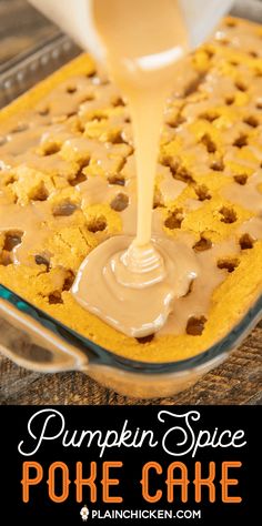 pumpkin spice poke cake in a glass pan with caramel sauce being poured on top