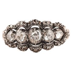 Antique ring featuring five white and lively rosecut diamonds. 1x approx 0,20ct + 2 x approx 0,15ct + 2 x approx 0,10ct + approx 28 x 0,005-0,01ct, total approx. 0.7. Ring size Ø17¾ US 7, stones set in closed back silver, shank 18 Karat yellow gold. Weight: 3,7g Rose Cut Diamond Ring, Rosecut Diamond Ring, Stone Rose, Antique Ring, Rose Cut Diamond, Antique Rings, Cluster Ring, Bridal Rings, Stone Settings