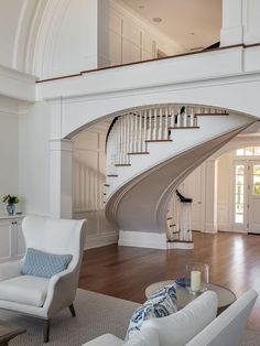 a living room filled with furniture and a spiral staircase