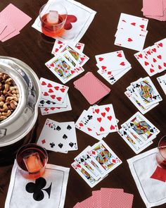 playing cards and wine glasses on a table