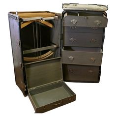 an open suitcase with several drawers and handles on the bottom, one opened to show its contents