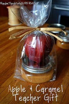 an apple and caramel teacher gift in a jar on a wooden table with text overlay