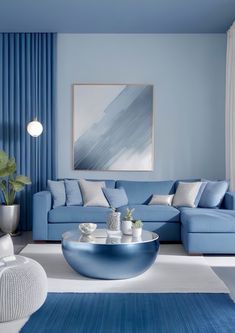 a living room with blue couches and white rugs on the floor in front of a painting