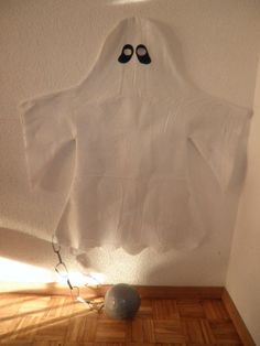 a white shirt with black shoes hanging on the wall